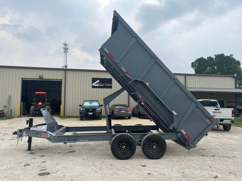 Heavy-duty dump trailer raised for loading at a construction site in Pensacola